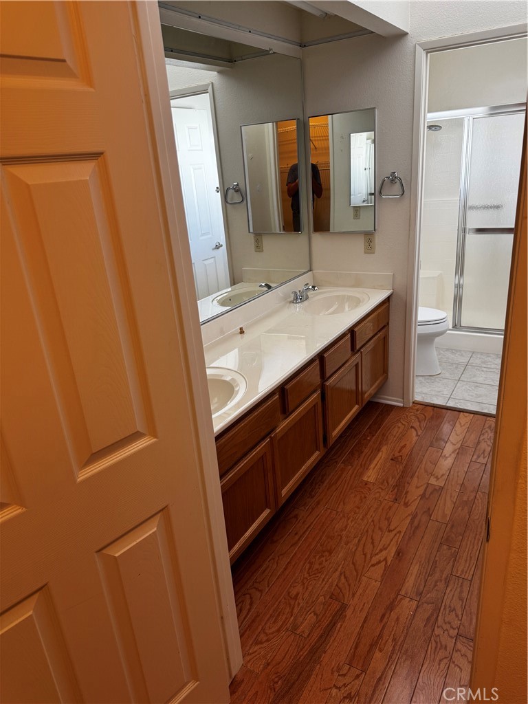 27519 Terrytown Road Menifee, CA 92586 - Photo 12 of 22 a bathroom with a double vanity sink and mirror