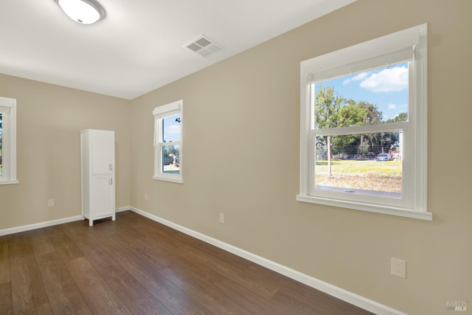 4851 Udell Road Vacaville, CA 95688 - Photo 16 of 65 a view of an empty room with wooden floor and a window