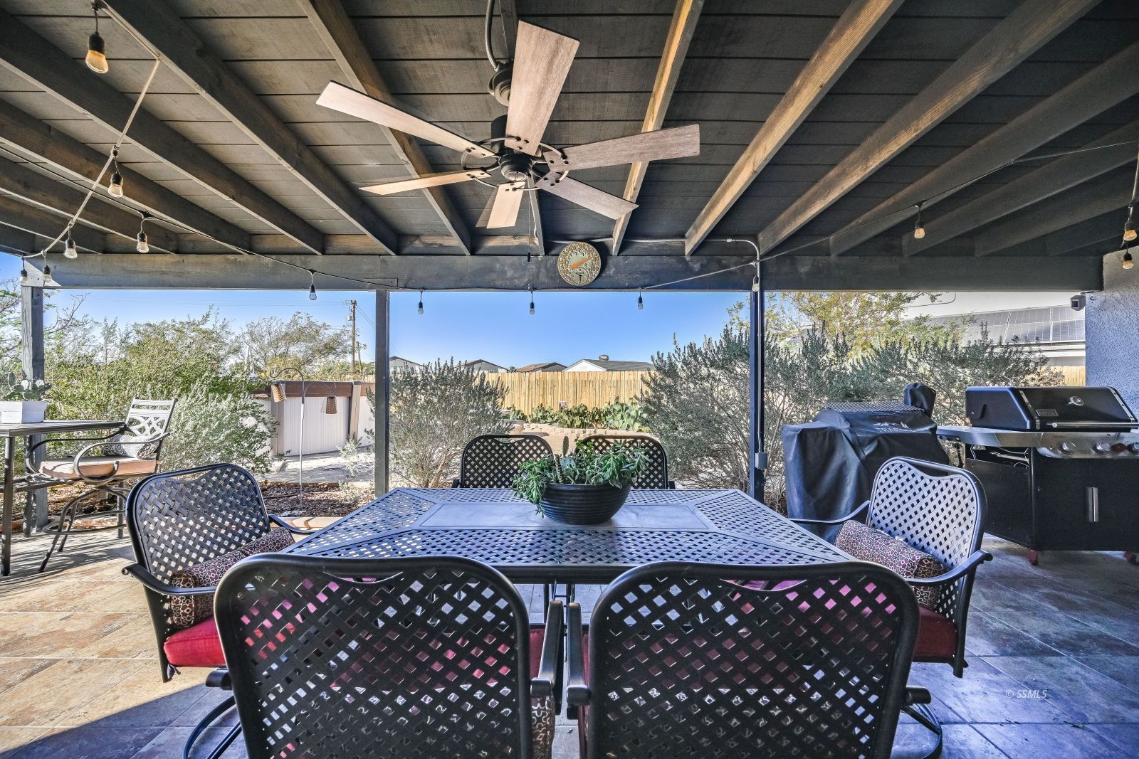 424 Marlene Court Ridgecrest, CA 93555 - Photo 36 of 38 a view of a patio with a table chairs and a wooden floor