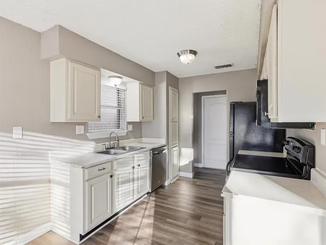 a kitchen with a sink stove and refrigerator