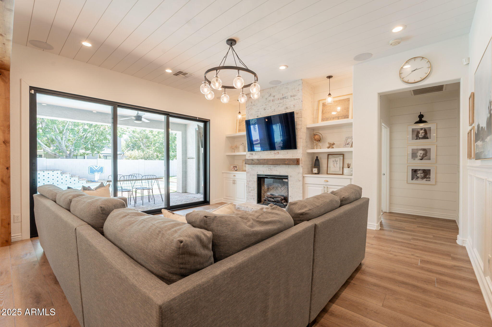 3931 East Weather Vane Road Gilbert, AZ 85296 - Photo 12 of 83 a living room with furniture a fireplace and a flat screen tv