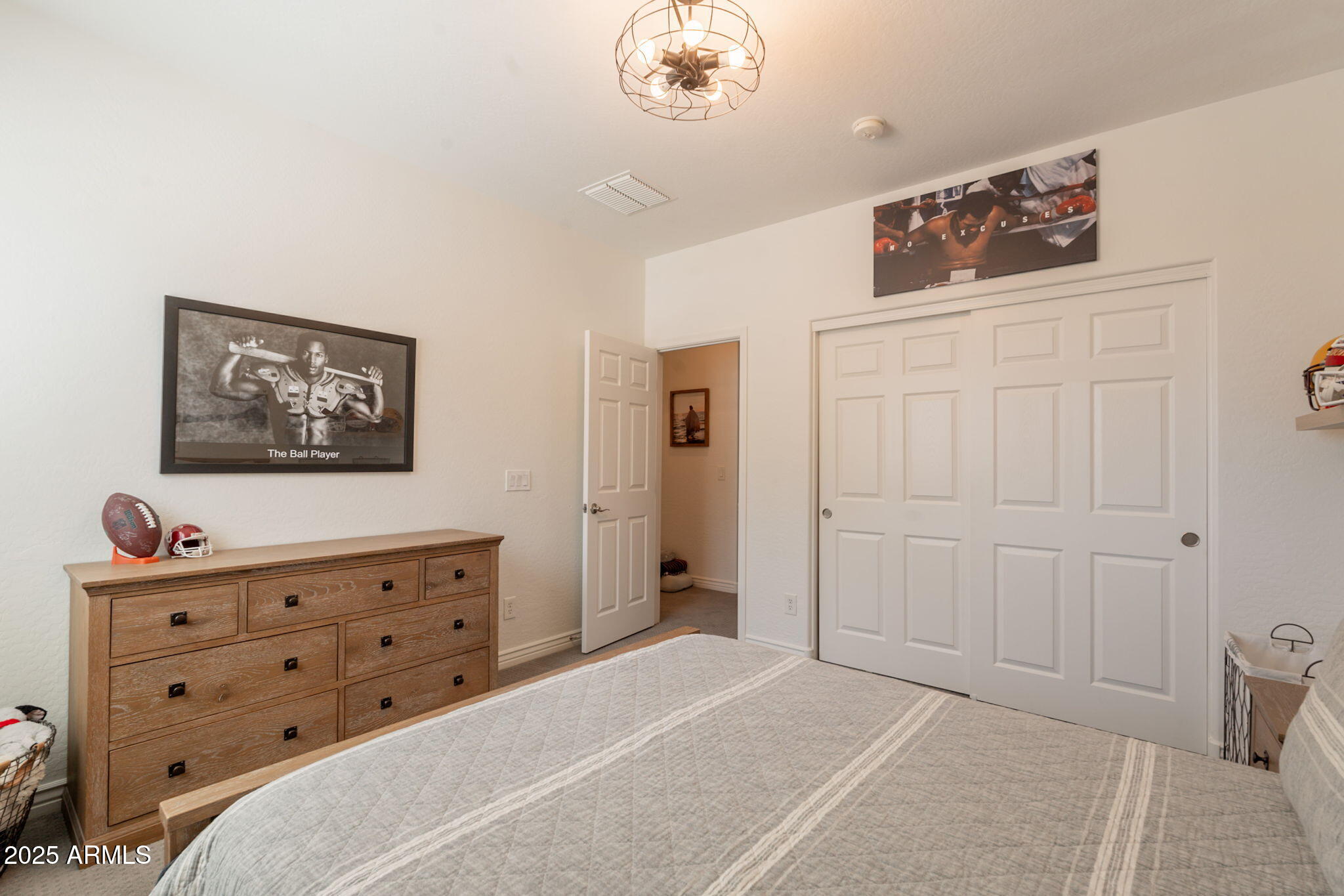 3931 East Weather Vane Road Gilbert, AZ 85296 - Photo 54 of 83 a bedroom with a dresser and a chandelier
