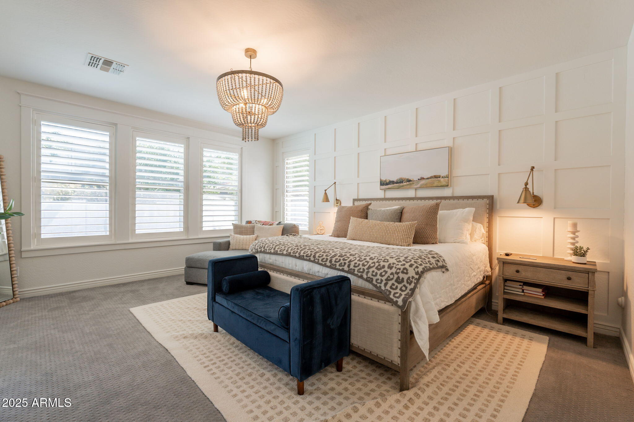 3931 East Weather Vane Road Gilbert, AZ 85296 - Photo 64 of 83 a bedroom with a large bed and a chandelier