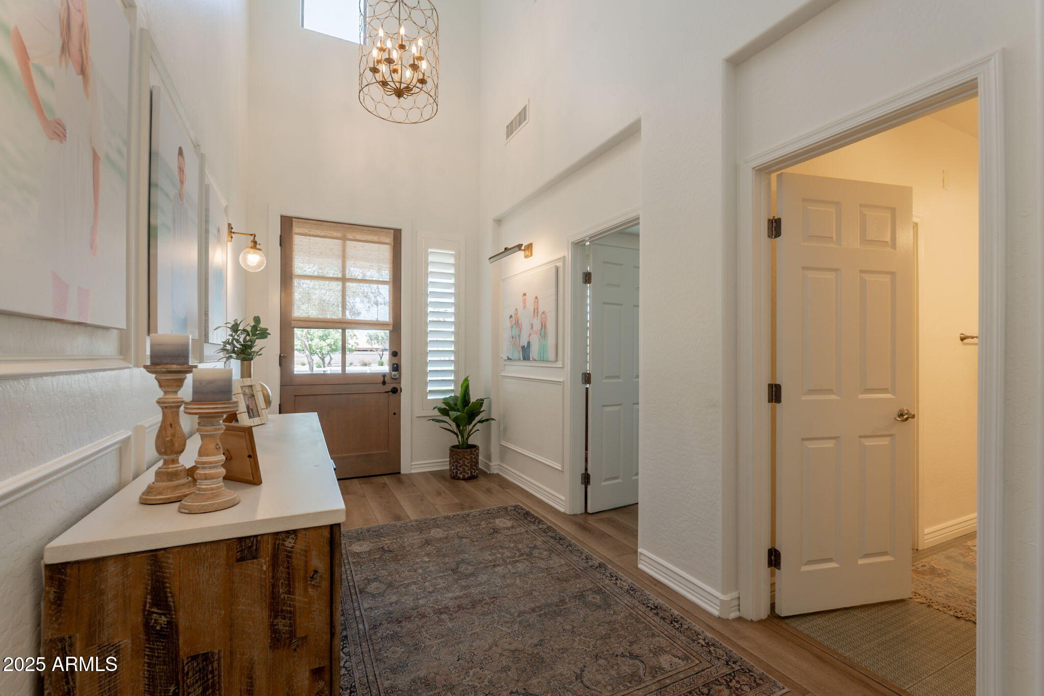 3931 East Weather Vane Road Gilbert, AZ 85296 - Photo 7 of 83 a view of a hallway to a livingroom with furniture