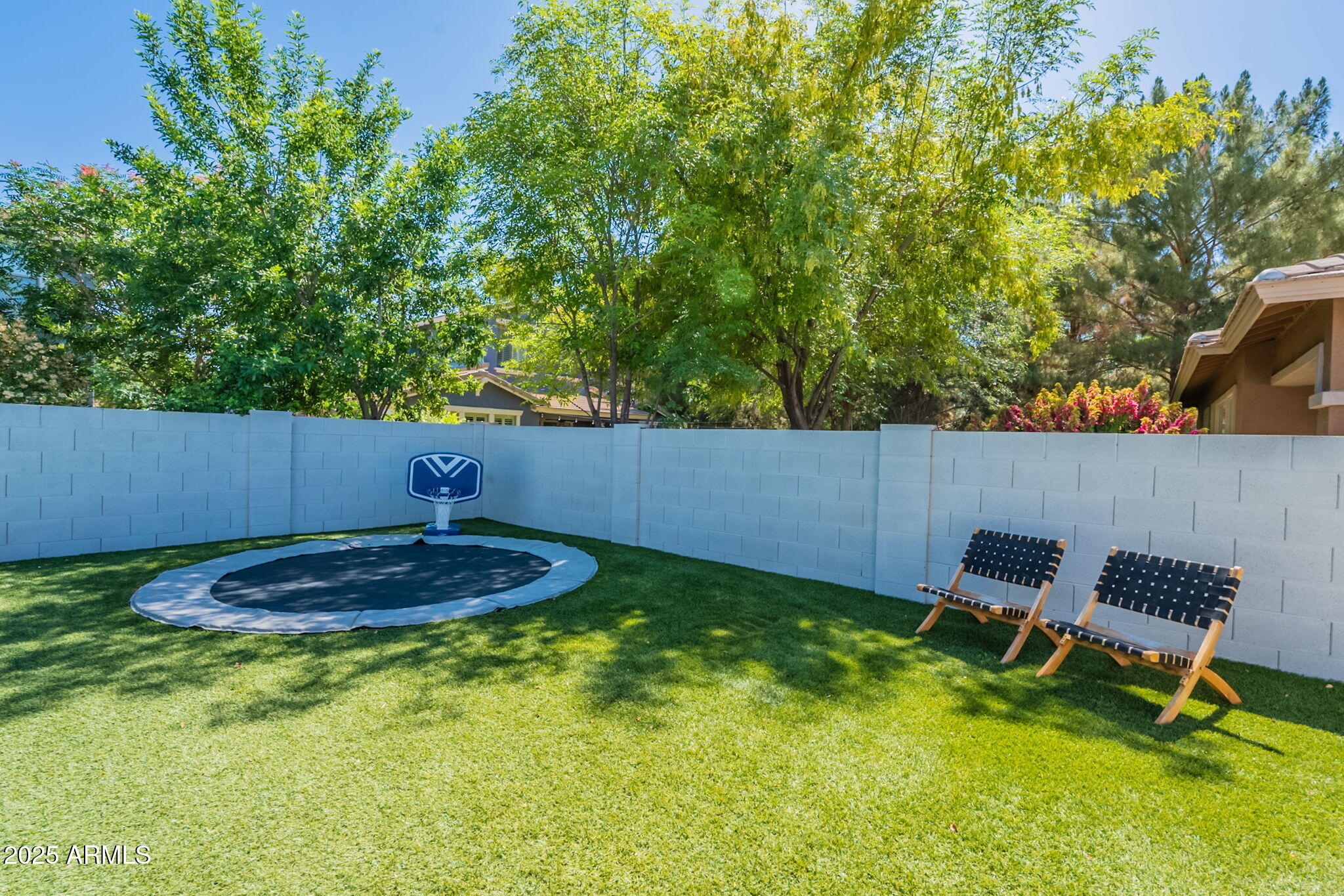 3931 East Weather Vane Road Gilbert, AZ 85296 - Photo 74 of 83 a backyard of a house with yard and trampoline