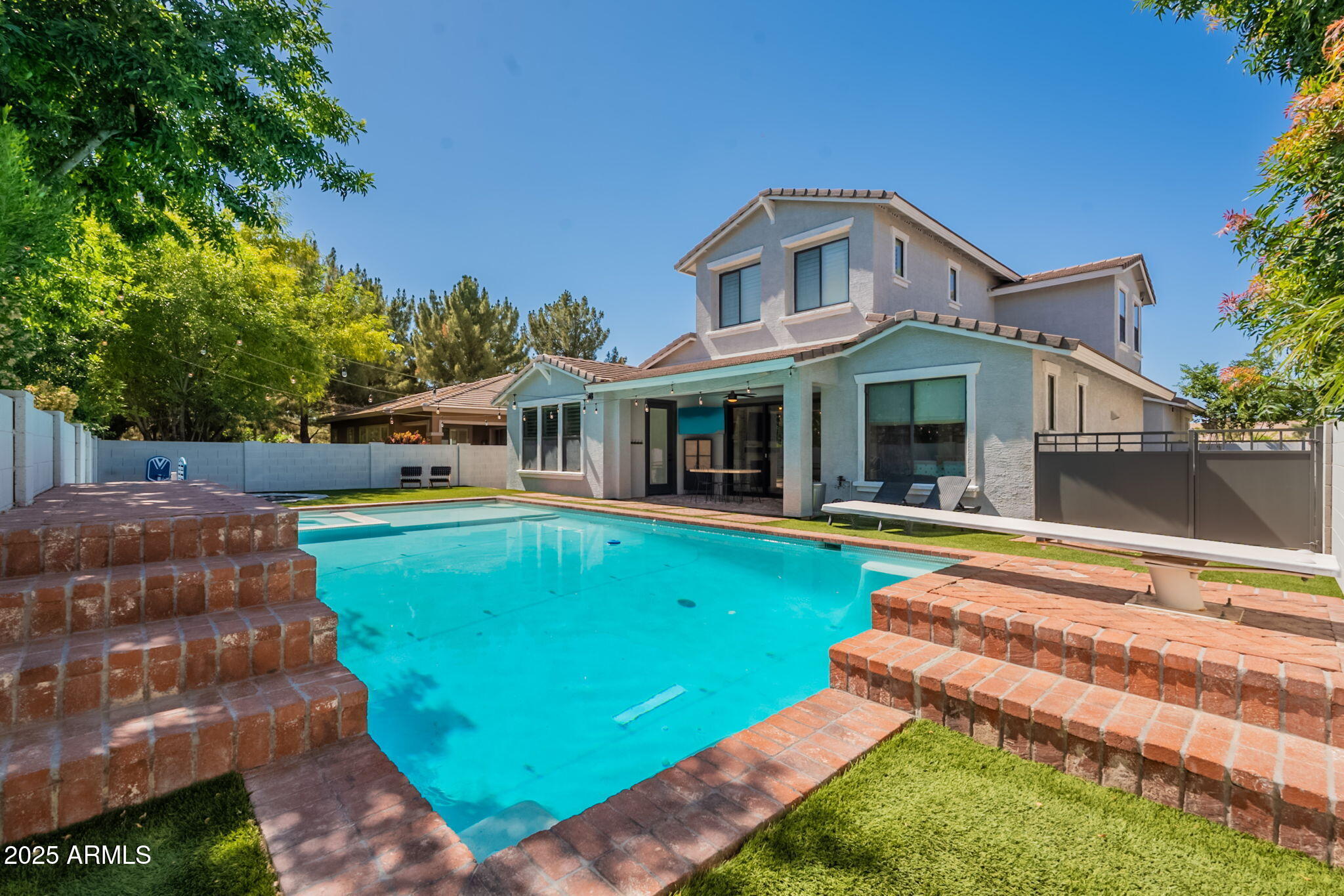 3931 East Weather Vane Road Gilbert, AZ 85296 - Photo 79 of 83 a front view of a house with swimming pool and porch