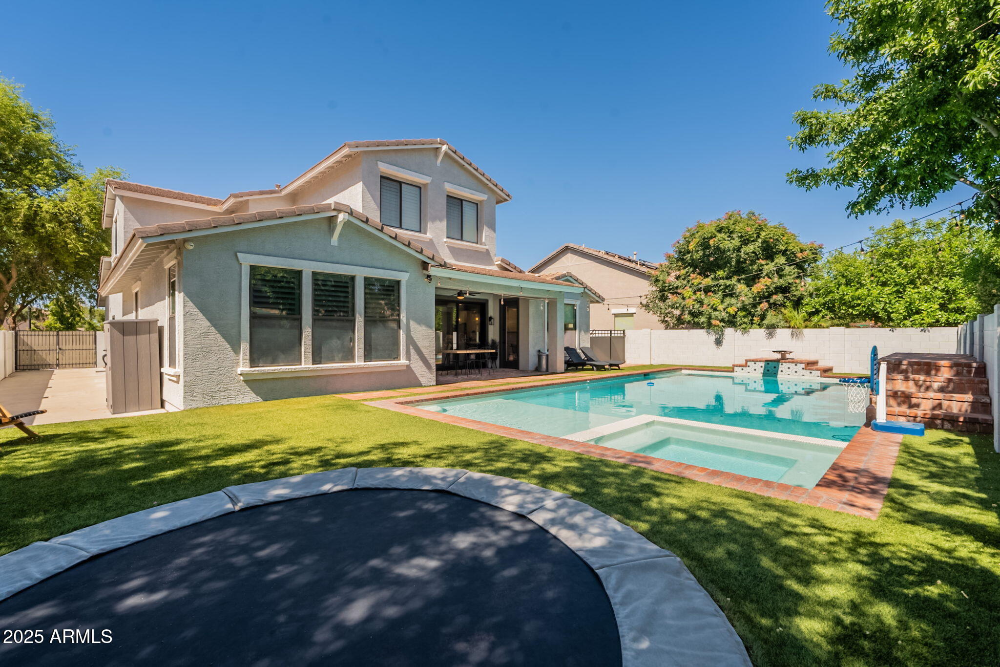 3931 East Weather Vane Road Gilbert, AZ 85296 - Photo 82 of 83 a front view of a house with a yard table and chairs
