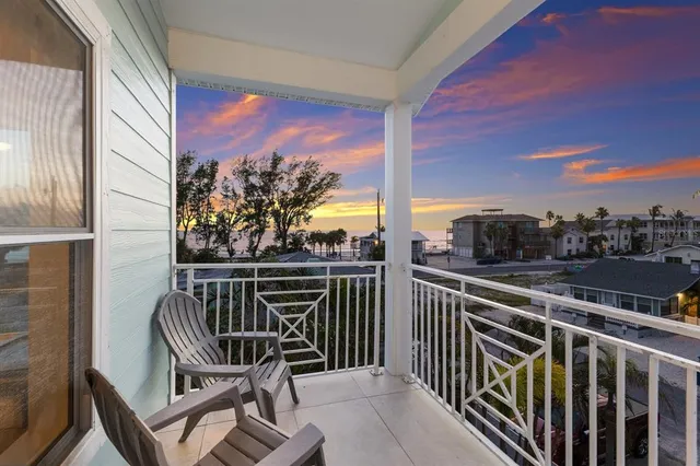 a view of a chair and tables in the balcony