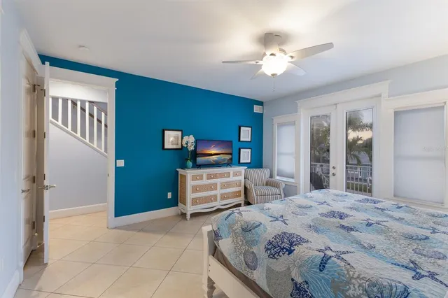 a bedroom with a large bed and a chandelier