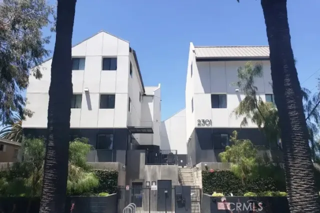 a front view of a house with plants