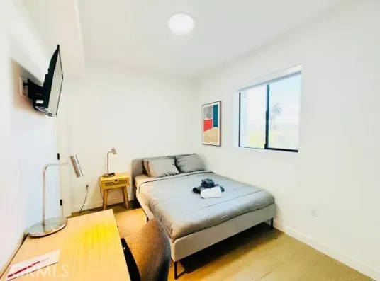 a bedroom with a bed and flat screen tv