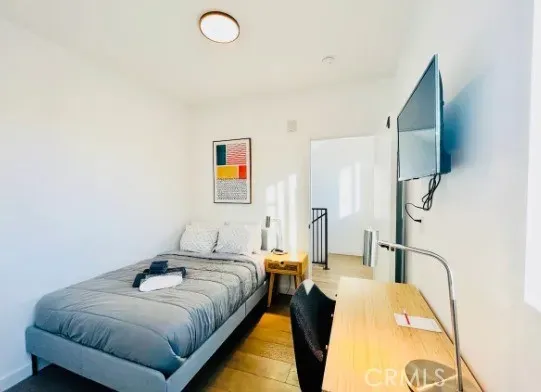 a bedroom with a bed and a flat screen tv