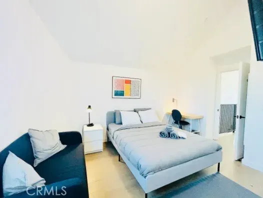 a bedroom with a bed and a couch