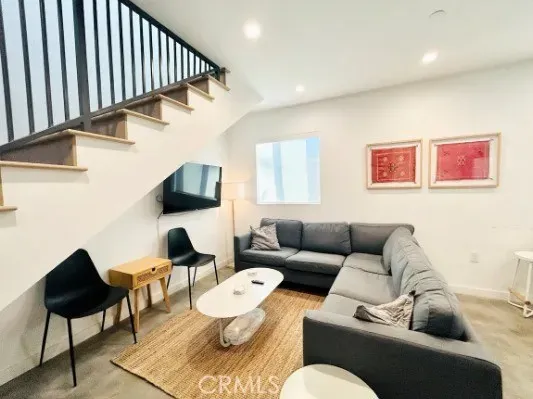 a living room with furniture and a painting