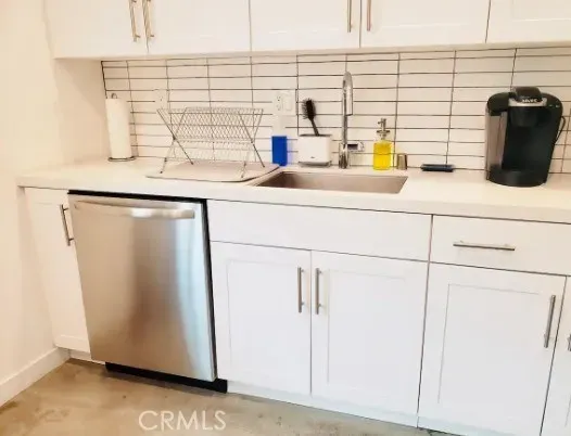 a kitchen with a refrigerator and a sink