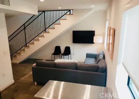 a living room with couches and a flat screen tv