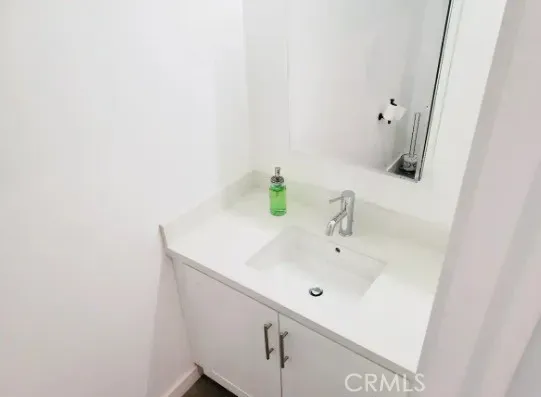 a bathroom with a sink and vanity