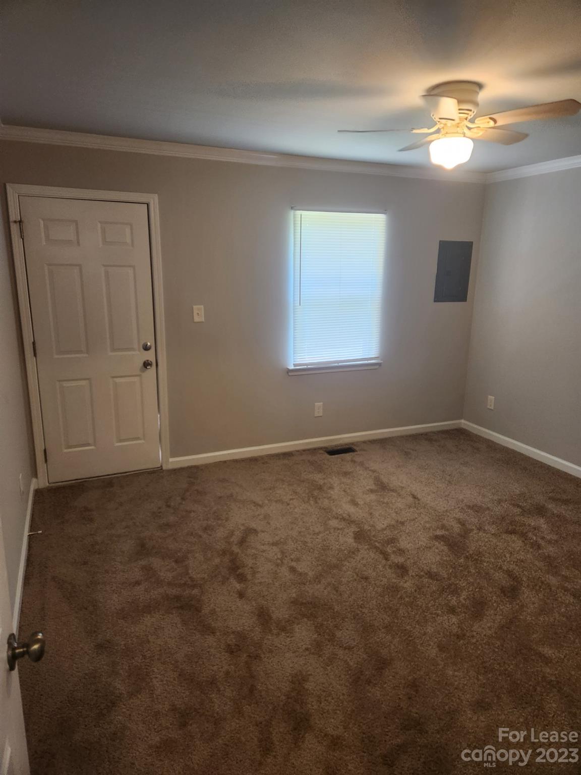 215 North Long Street, Unit B Salisbury, NC 28144 - Photo 2 of 5 en empty room with windows and chandelier fan