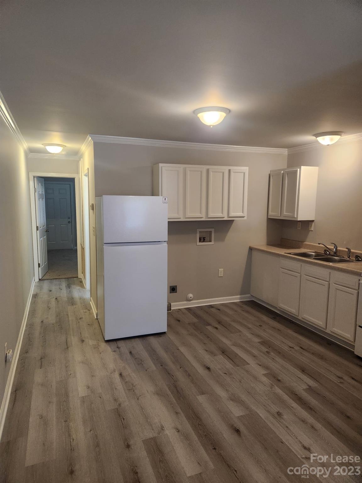 215 North Long Street, Unit B Salisbury, NC 28144 - Photo 4 of 5 a kitchen with a refrigerator and a stove top oven