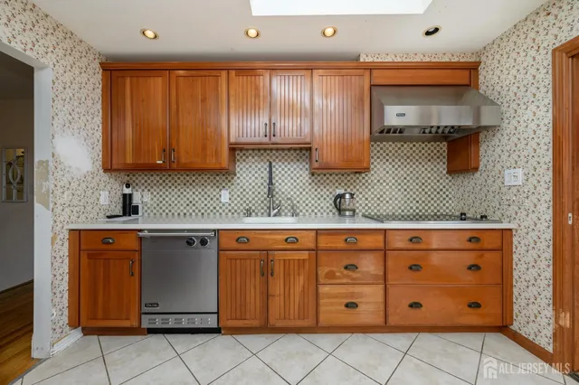 a kitchen with stainless steel appliances granite countertop a sink and cabinets