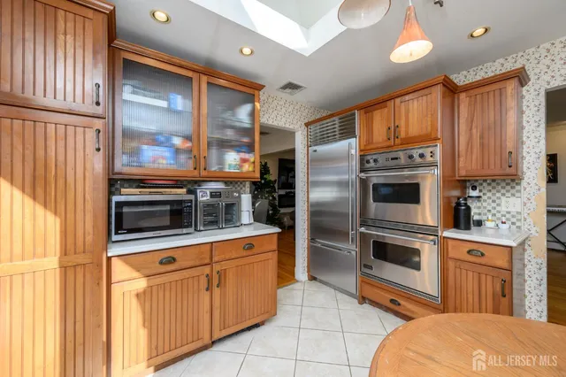a kitchen with stainless steel appliances a stove a sink and a refrigerator