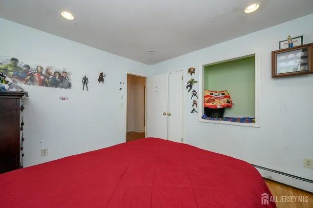 a bedroom with a bed and painting on the wall