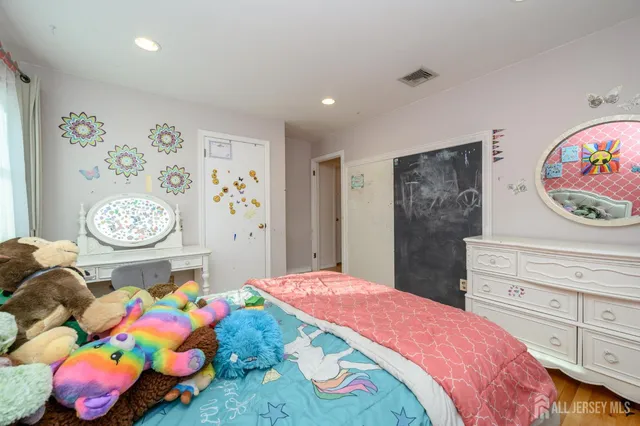 a bedroom with a bed and dresser