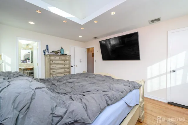 a bedroom with a bed and a flat screen television