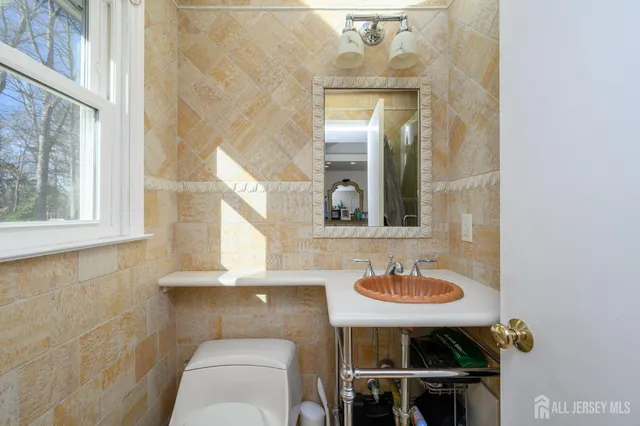 a bathroom with a sink a mirror and a window