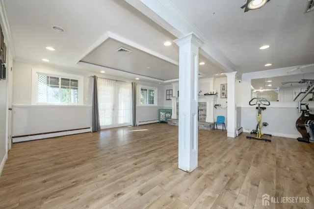 a view of a room with gym equipment and a window