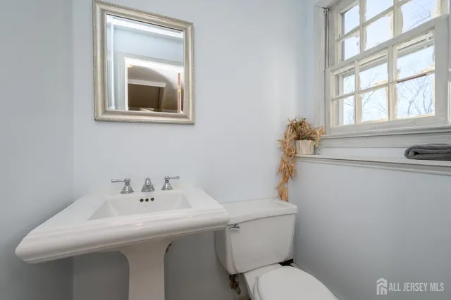 a bathroom with a sink mirror and toilet