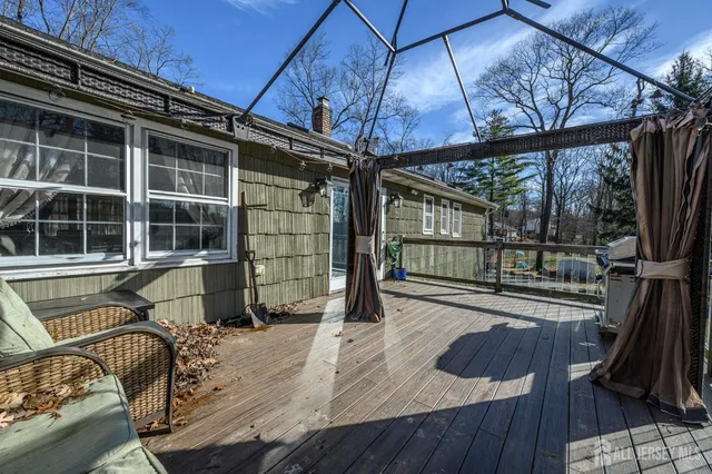a view of a balcony with table and chairs and wooden floor