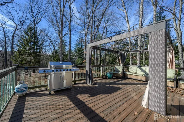 a view of a patio with table and chairs wooden floor and fence