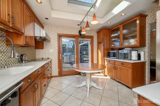 a kitchen with stainless steel appliances granite countertop a sink and cabinets