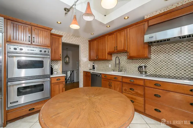 a kitchen with granite countertop a stove sink and cabinets