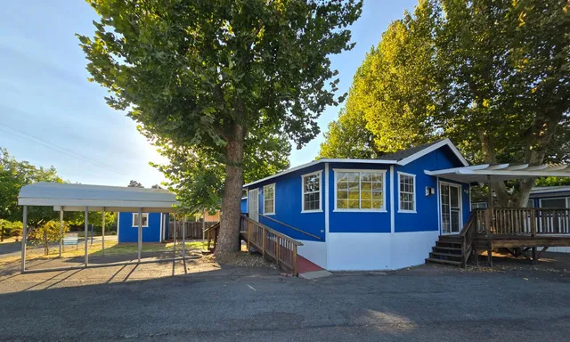 a view of a house with a yard and sitting area