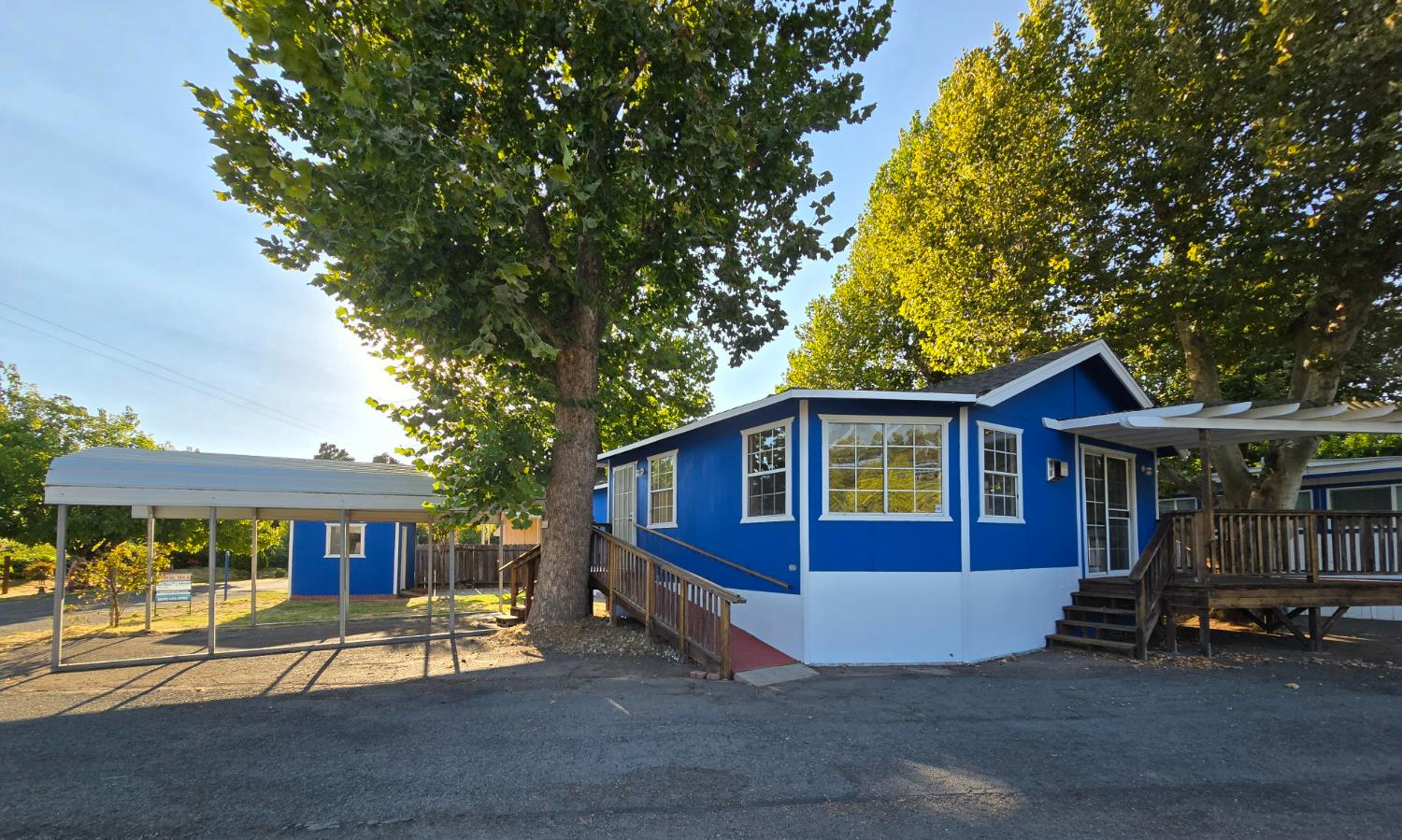 a view of a house with a yard and sitting area