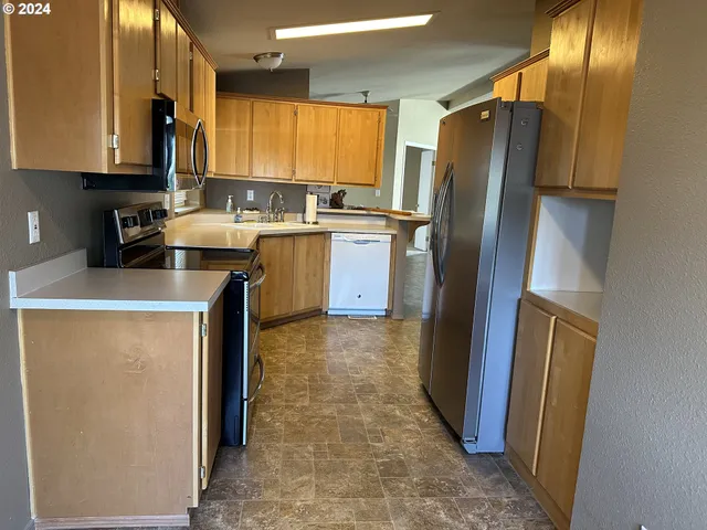 a kitchen with a refrigerator sink and stove
