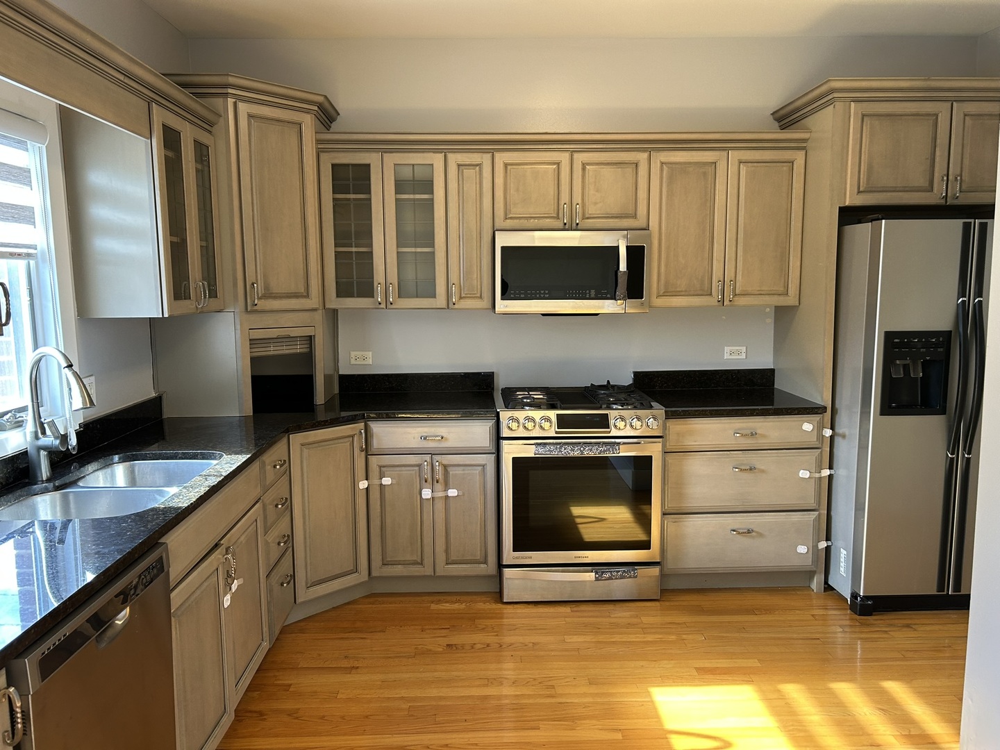 9207 Gerritsen Avenue, Unit 9207 Brookfield, IL 60513 - Photo 13 of 24 a kitchen with stainless steel appliances granite countertop a stove a sink and a microwave