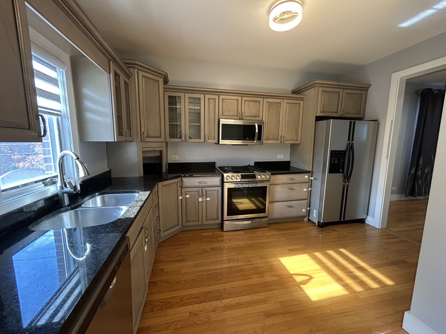 9207 Gerritsen Avenue, Unit 9207 Brookfield, IL 60513 - Photo 14 of 24 a kitchen with stainless steel appliances granite countertop a stove a sink and a refrigerator