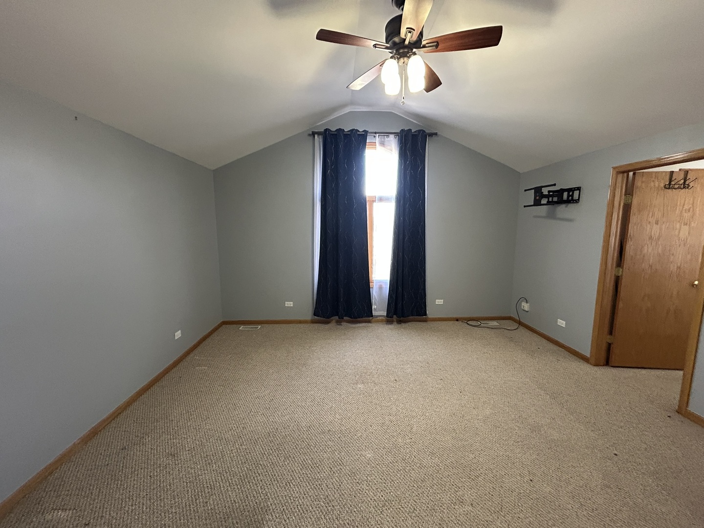 9207 Gerritsen Avenue, Unit 9207 Brookfield, IL 60513 - Photo 20 of 24 an empty room with chandelier fan and windows