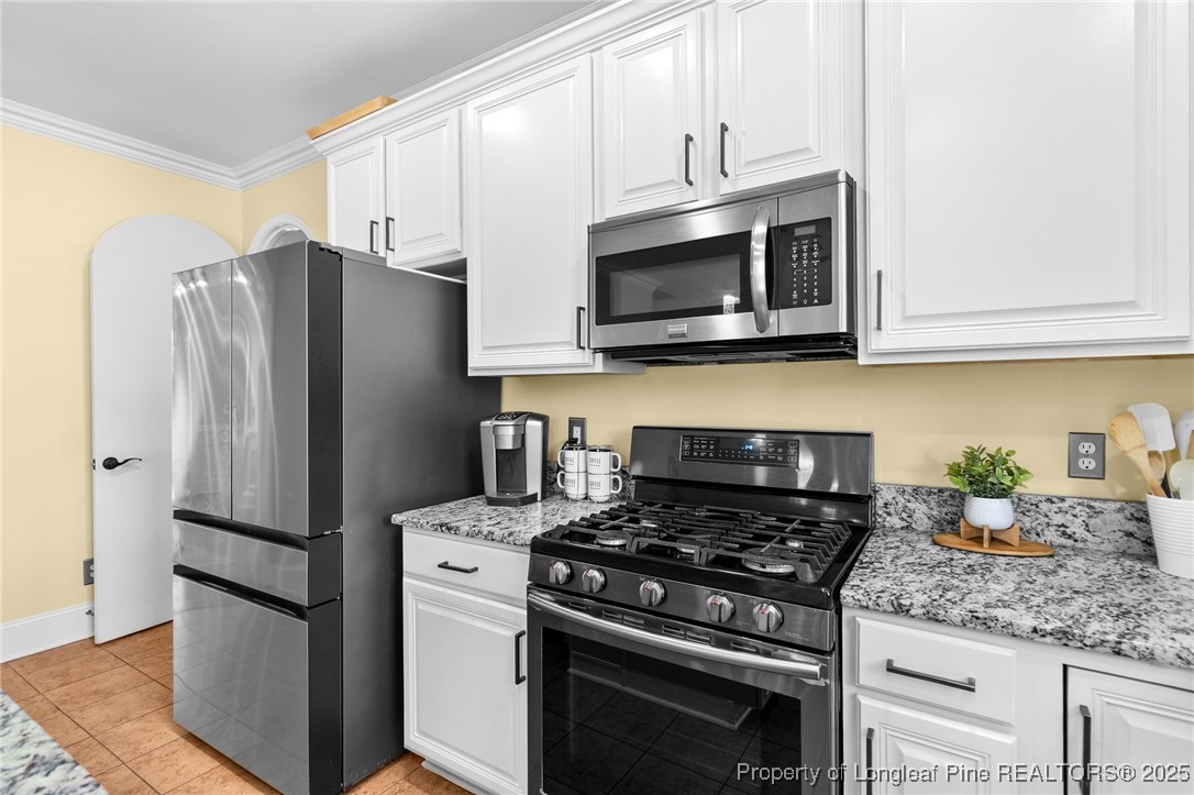 499 Price Road Fairmont, NC 28340 - Photo 12 of 50 a kitchen with stainless steel appliances granite countertop a refrigerator stove and microwave
