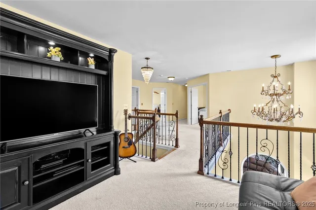 a view of a livingroom with furniture and a flat screen tv