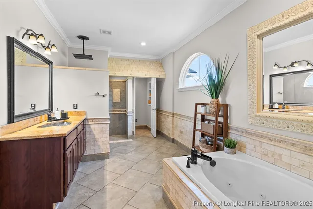a bathroom with a tub a sink and a mirror