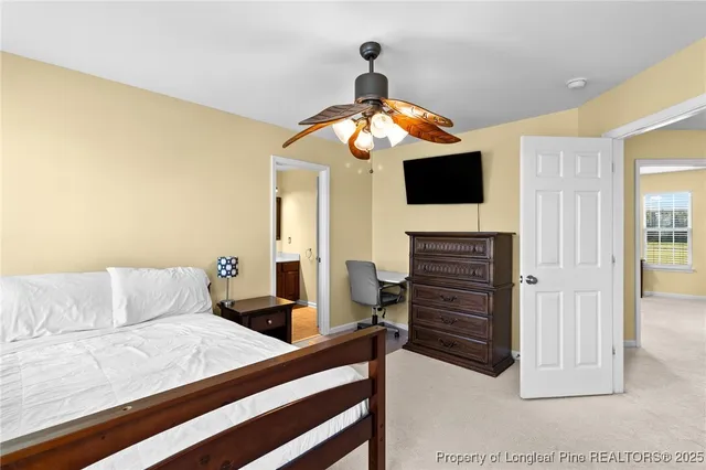 a bedroom with a bed and a television