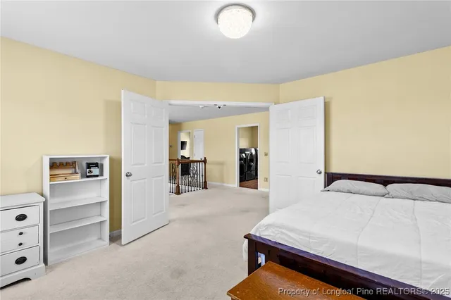 a bedroom with a bed and cabinets