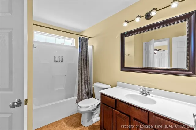 a bathroom with a sink vanity mirror and toilet