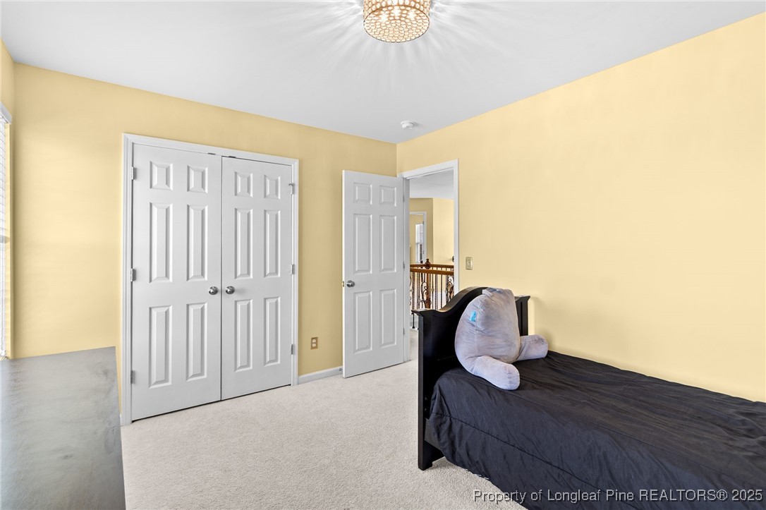 499 Price Road Fairmont, NC 28340 - Photo 35 of 50 a bedroom with a bed and a chandelier