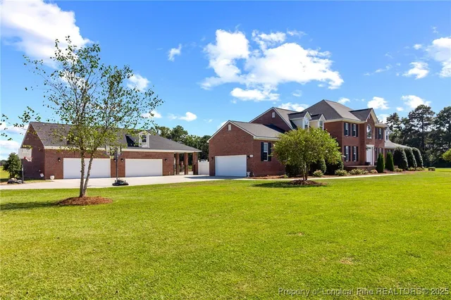 a front view of house with yard and swimming pool