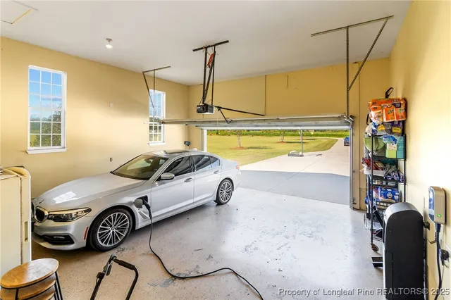 a view of a livingroom with furniture and floor to ceiling window